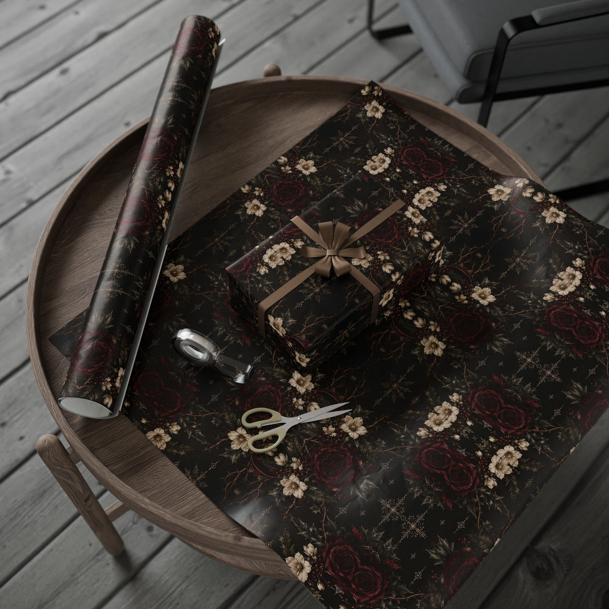 Dark Vintage Floral wrapping paper arranged on a round tray with a wrapped present and paper roll, with scissors and tape nearby.