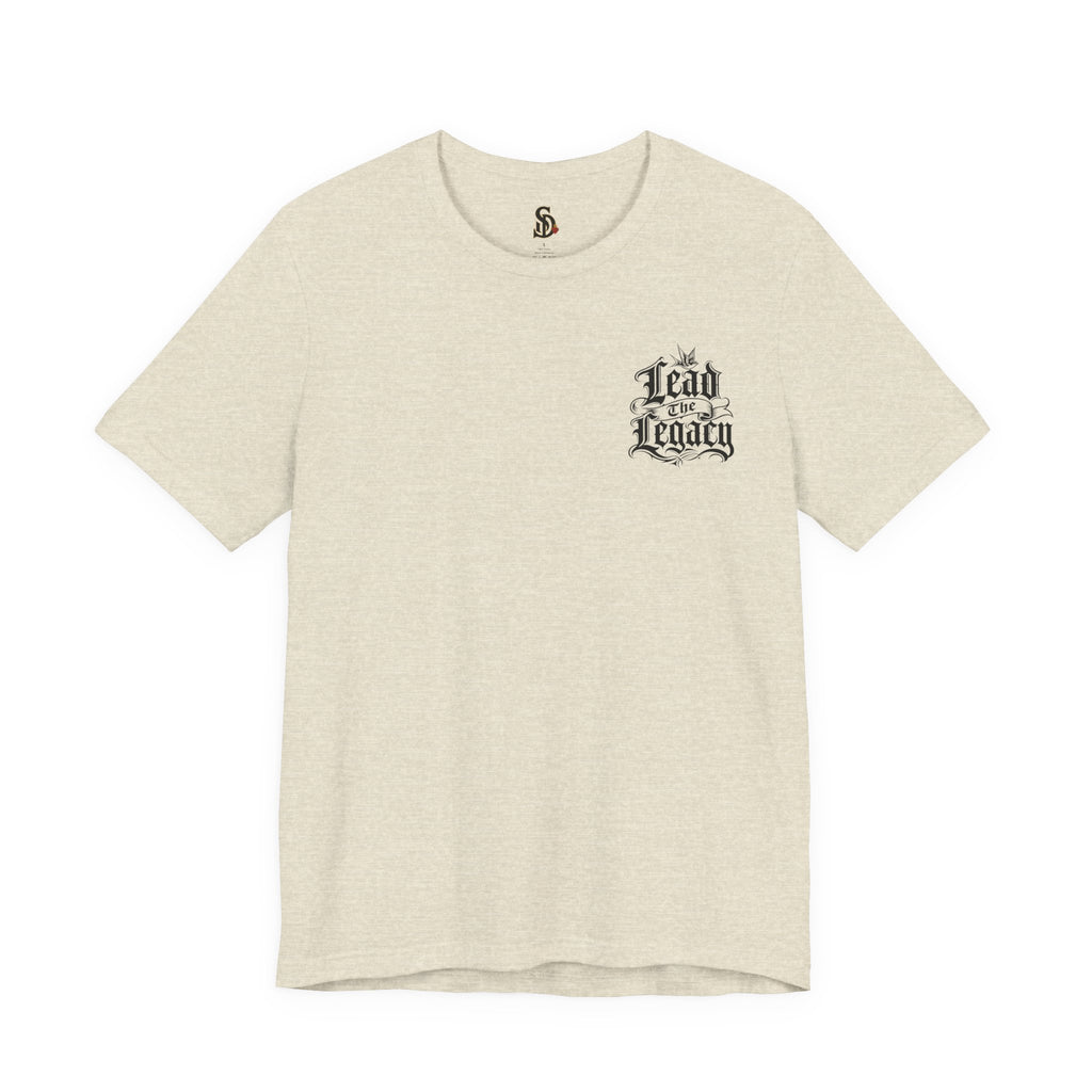 Lead the Legacy Graphic Tee heather prism natural front flat-lay — Lead the Legacy gothic script left chest pocket logo