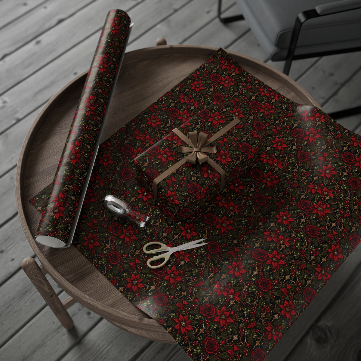 Dark Botanical Floral wrapping paper arranged on a round tray with a wrapped present and paper roll, with scissors and tape nearby.