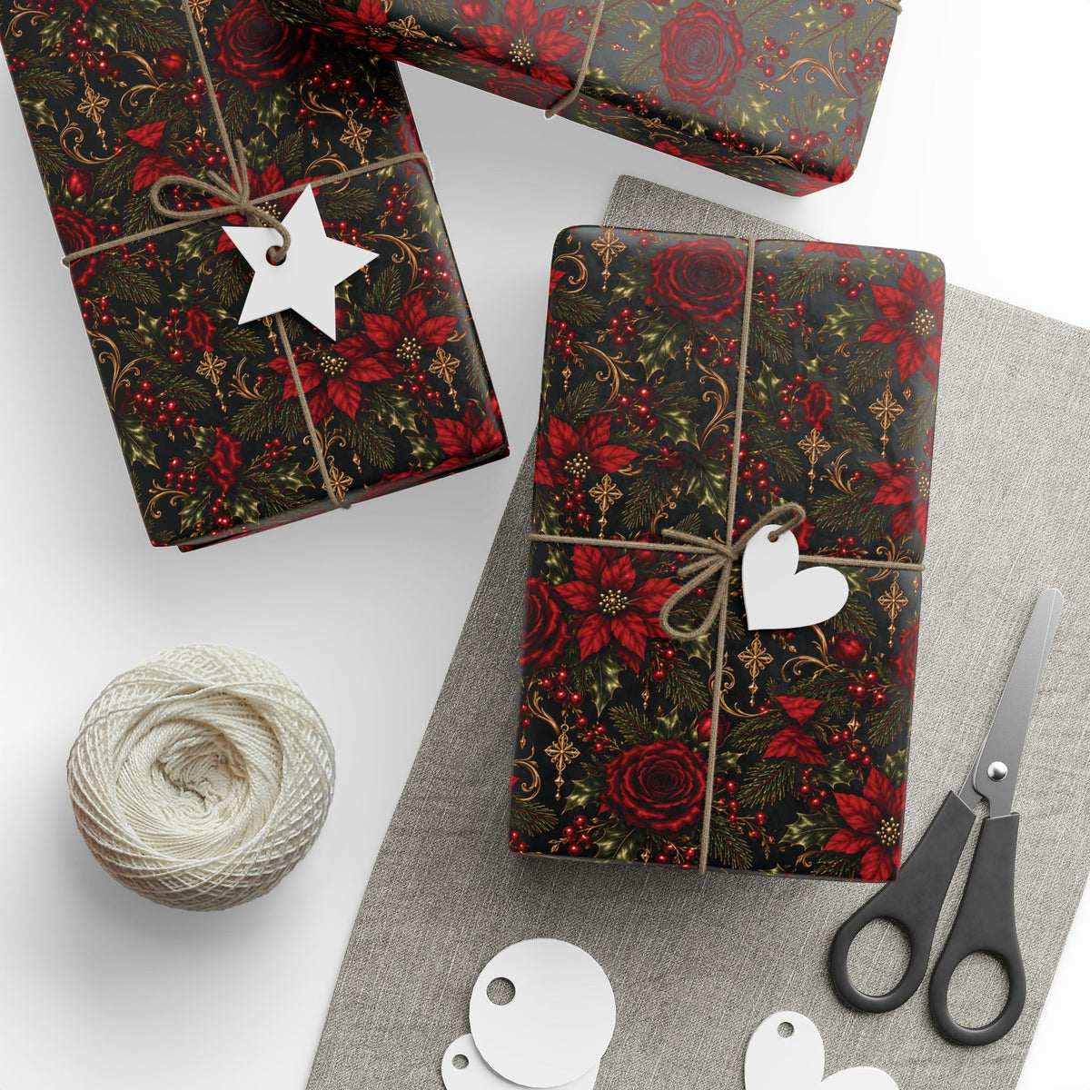 Several gifts wrapped in Dark Botanical Floral paper with twine and tags, arranged beside scissors and a ball of twine.