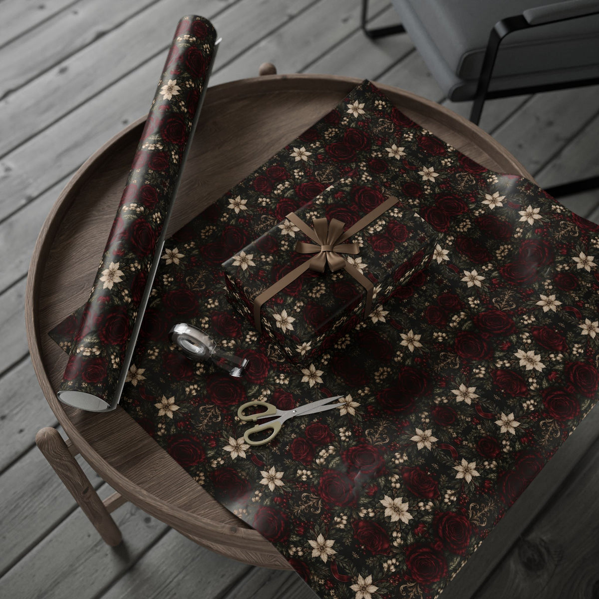 Burgundy Floral Pattern wrapping paper arranged on a round tray with a wrapped present and paper roll, with scissors and tape nearby.