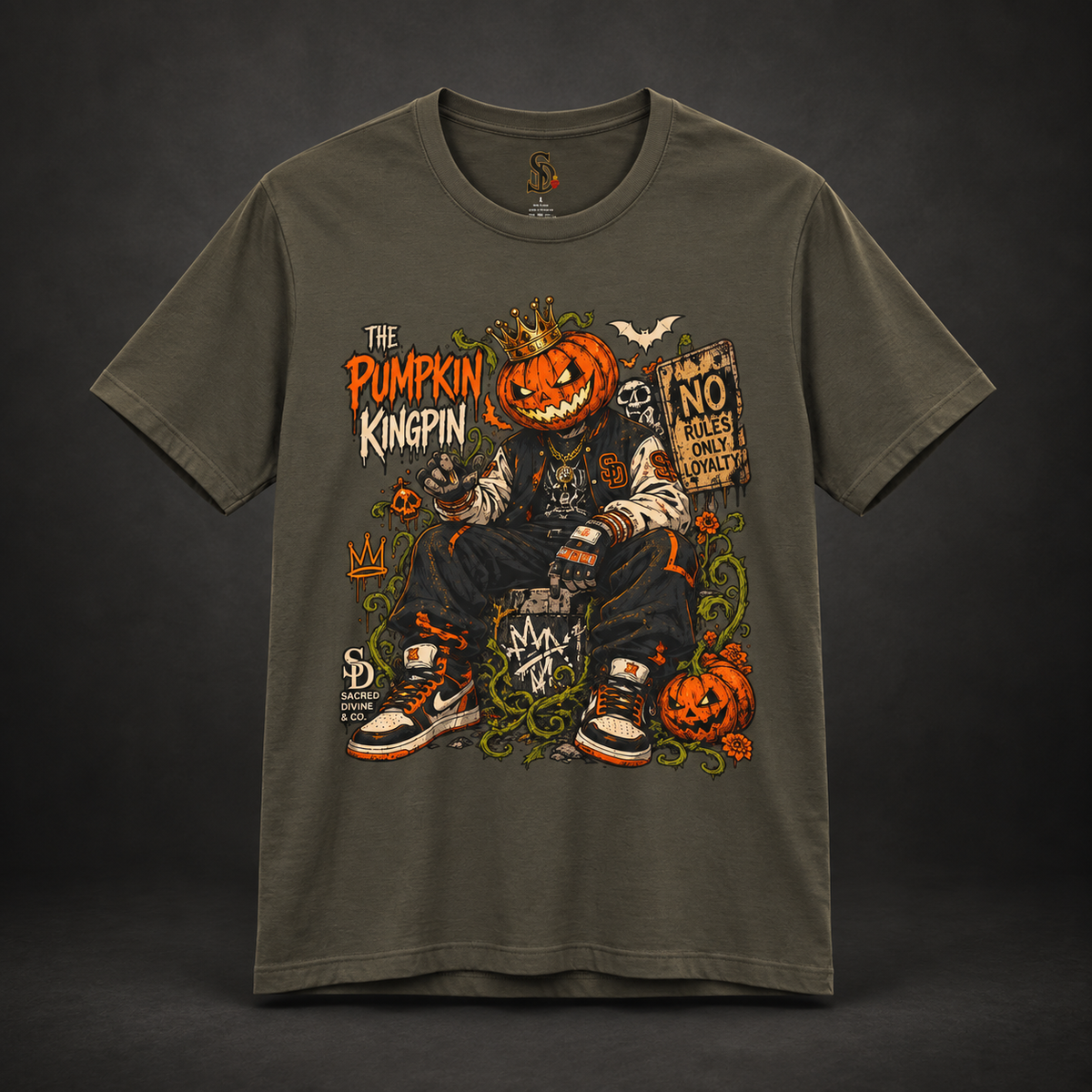 The Pumpkin Kingpin Tee styled product image with crowned jack-o'-lantern holding a No Rules Only Loyalty sign