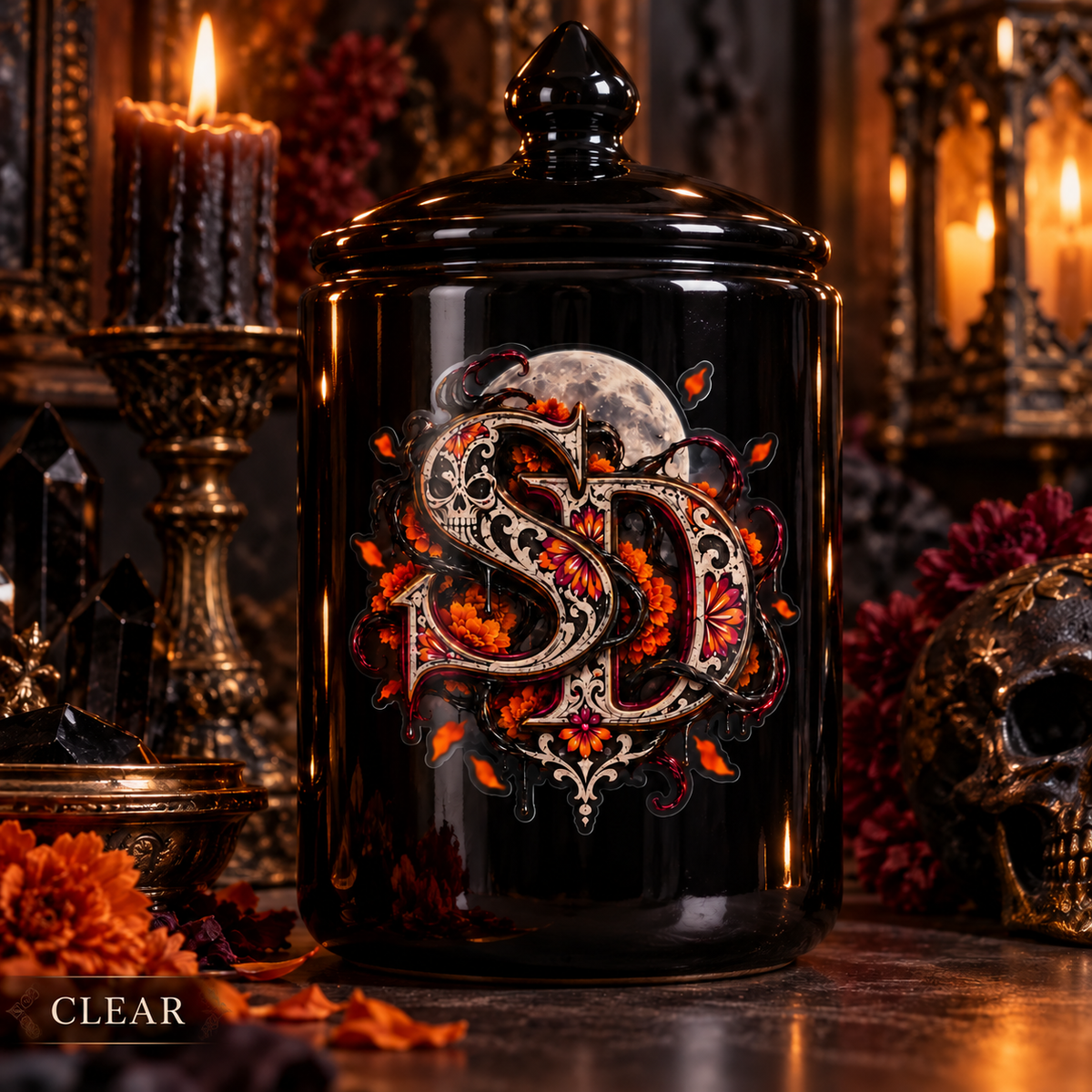 Clear Día de los Muertos SD decal displayed on a black glass jar amid candles.