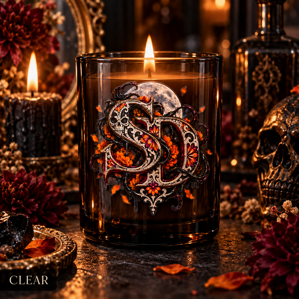 Clear Día de los Muertos SD decal on an amber candle vessel in a gothic setting.