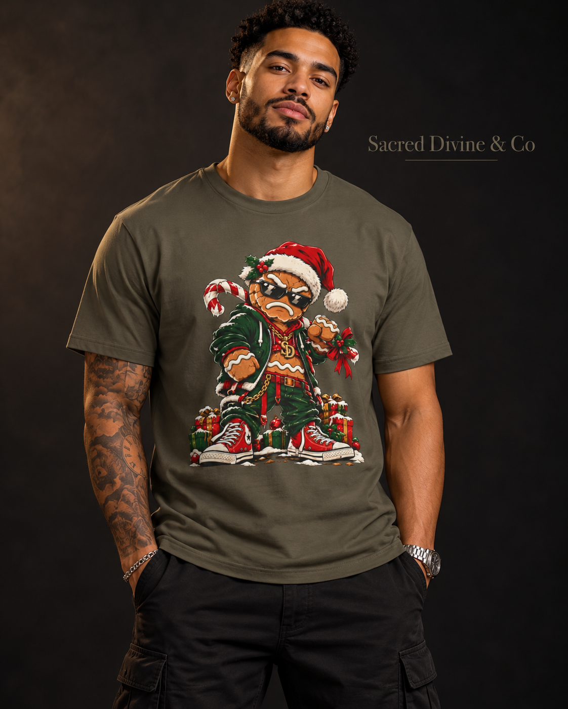 Model wearing an Army Gingerbread Outlaw Tee, front view with a gingerbread character in a Santa hat and red sneakers.