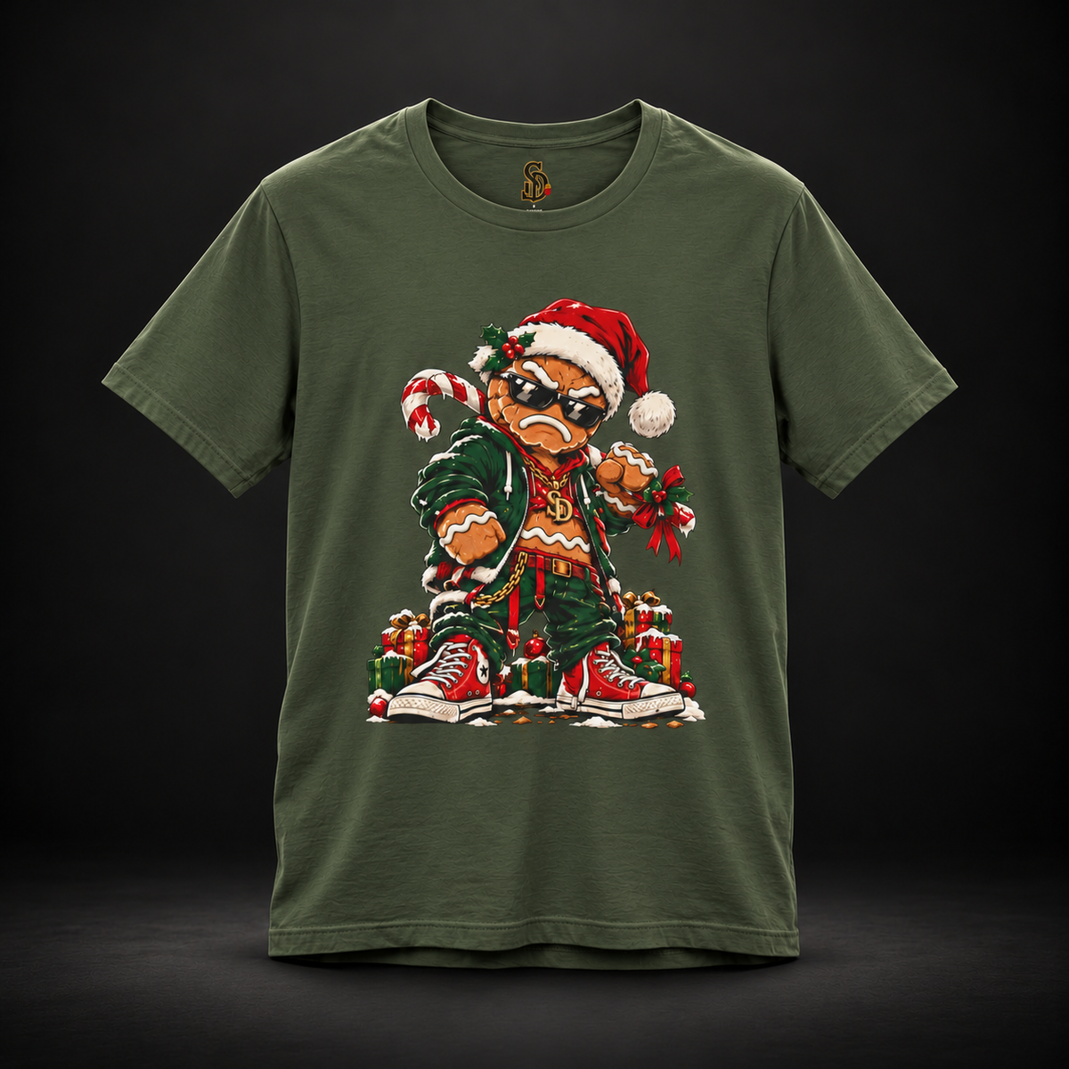 Military Green Gingerbread Outlaw Tee, front view with gingerbread Christmas character artwork.
