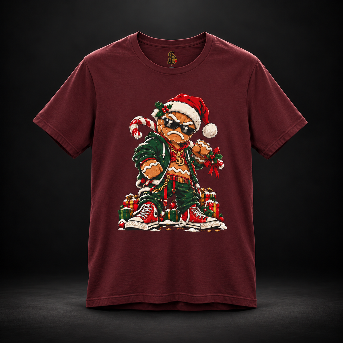 Maroon Gingerbread Outlaw Tee, front view with gingerbread Christmas character artwork.