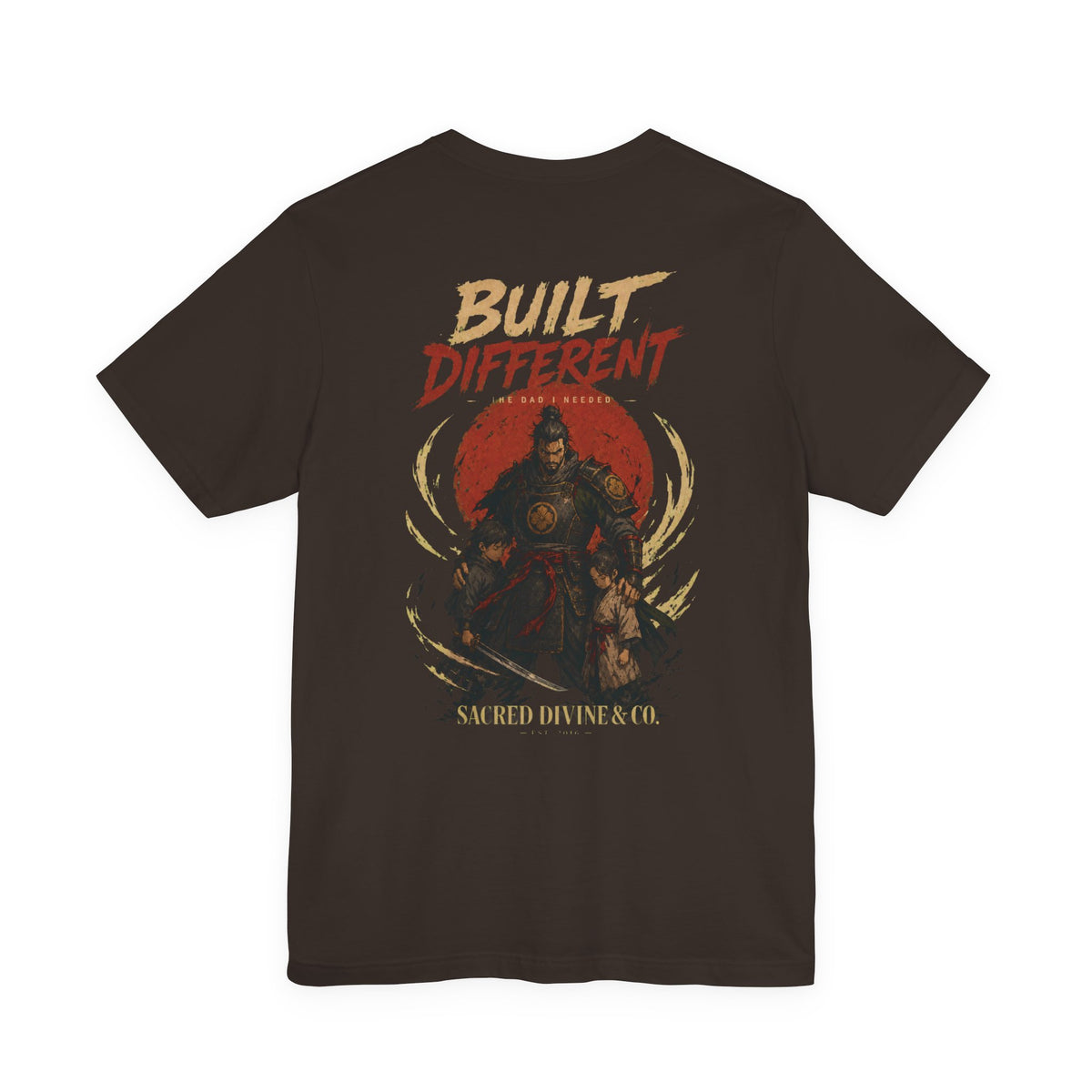 Built Different Tee dark brown back flat-lay — Built Different The Dad I Needed warrior crest full back graphic and Sacred Divine & Co. wordmark