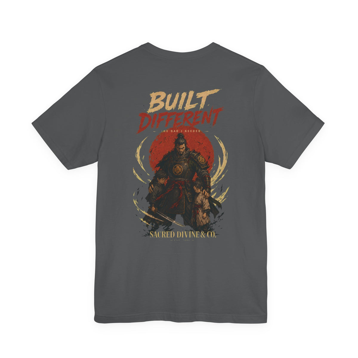 Built Different Tee charcoal back flat-lay — Built Different The Dad I Needed warrior crest full back graphic and Sacred Divine & Co. wordmark