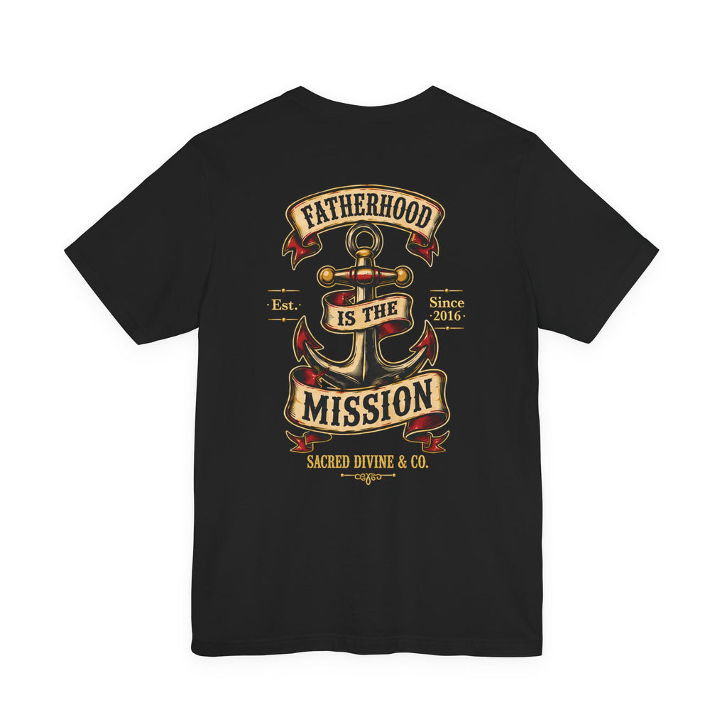 Fatherhood Is the Mission Tee black back flat-lay — Fatherhood Is the Mission vintage anchor banner full back graphic with Sacred Divine & Co. wordmark