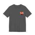 Built Different Tee charcoal front flat-lay — The Dad I Needed red circle left chest badge with SD monogram neck label