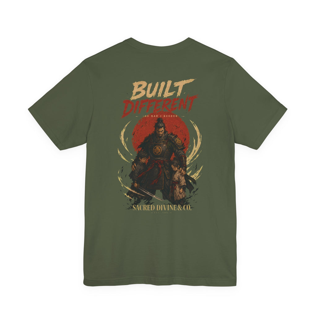 Built Different Tee military green back flat-lay — Built Different The Dad I Needed warrior crest full back graphic and Sacred Divine & Co. wordmark