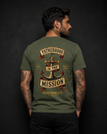 Fatherhood Is the Mission Tee military green back lifestyle — model wearing tee with Fatherhood Is the Mission vintage anchor banner full back graphic and Sacred Divine & Co. wordmark