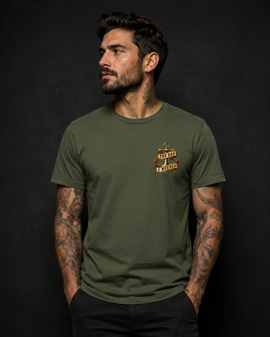 Fatherhood Is the Mission Tee military green front lifestyle — model wearing tee with The Dad I Needed vintage anchor left chest graphic