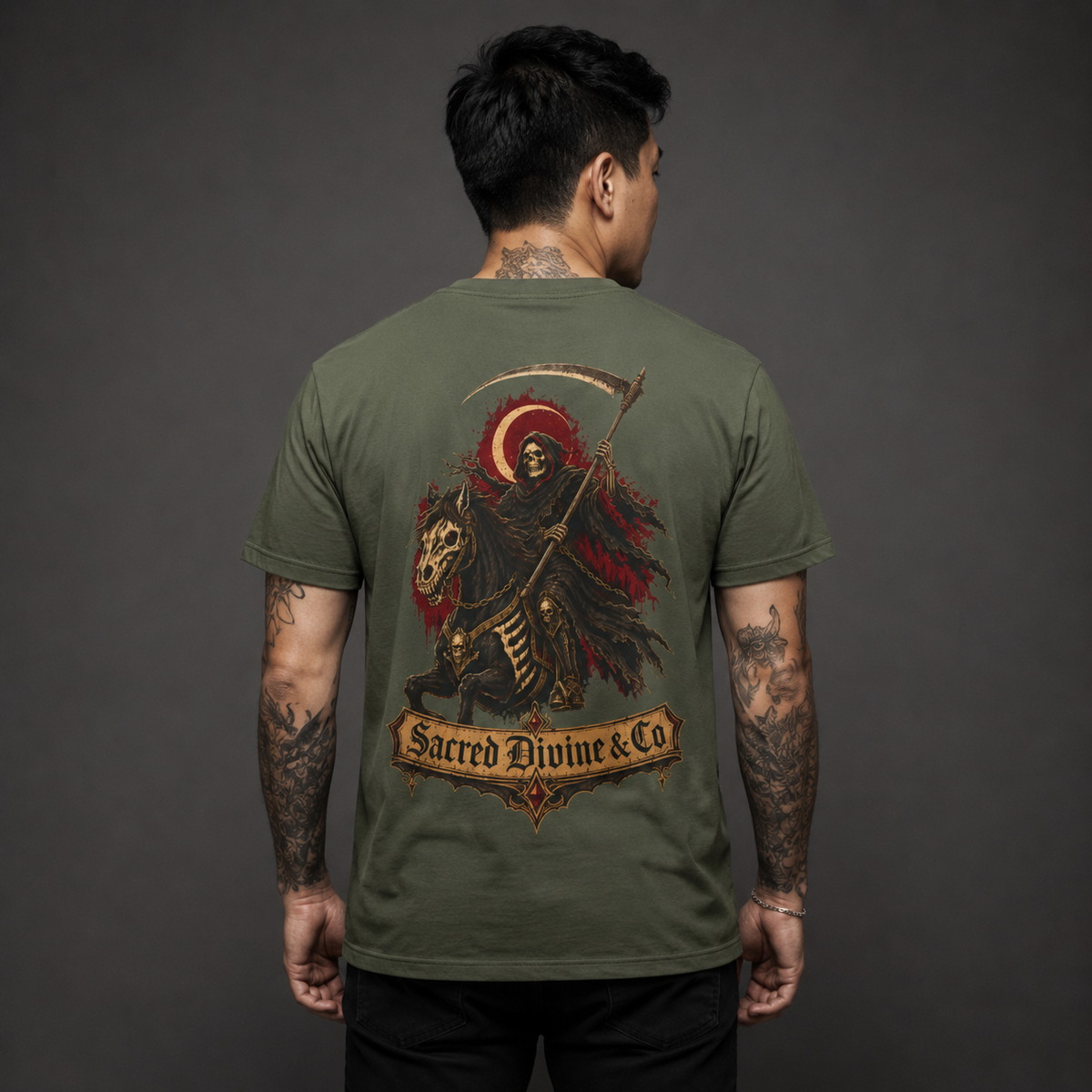 Grim Reaper Graphic Tee military green back lifestyle — model wearing tee with Grim Reaper on skeleton horse scythe crescent moon Sacred Divine & Co. scroll banner full back graphic